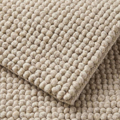Chunky wool rug with neutral tones and handwoven thick loop pile for cozy minimalist farmhouse and Scandinavian decor
