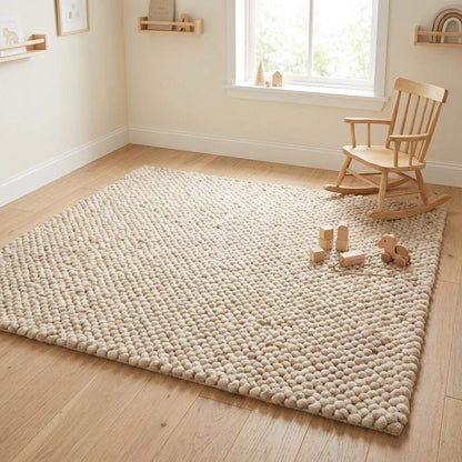 Handmade chunky wool rug with thick knit texture in neutral beige, perfect for cozy living room and bedroom decor
