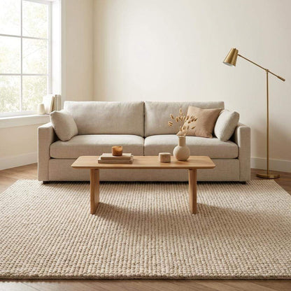 Handmade chunky wool rug in neutral tones with thick, soft texture for cozy minimalist living room decor