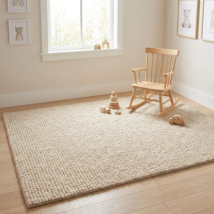 Handmade chunky wool rug in neutral tones with thick, soft texture for cozy minimalist living room decor