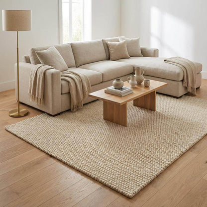 Chunky wool rug in neutral ivory with thick plush texture in a minimalist Scandinavian living room setting