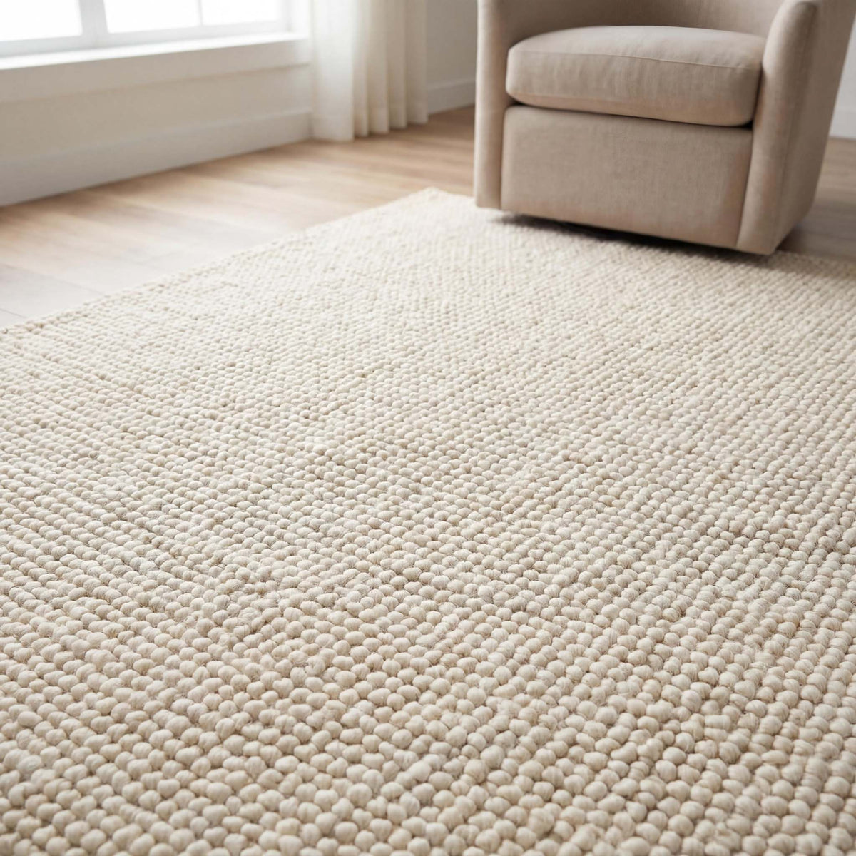 Handmade chunky wool rug with thick texture in neutral tones for cozy minimalist living room decor
