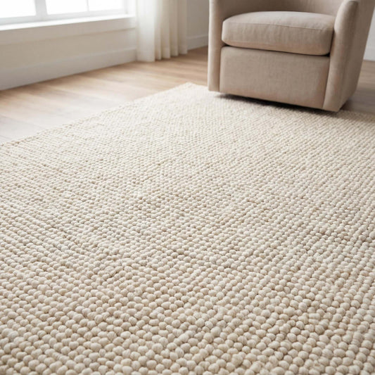 Handmade chunky wool rug with thick texture in neutral tones for cozy minimalist living room decor
