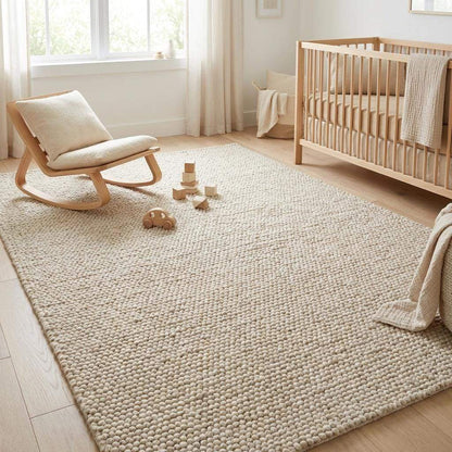 Handmade chunky wool rug with thick textured natural fibers in neutral tones for cozy minimalist decor