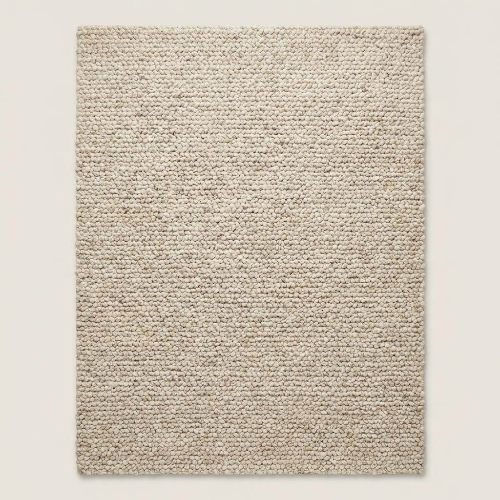 Handmade chunky wool rug with thick texture in neutral tones for cozy minimalist living room decor