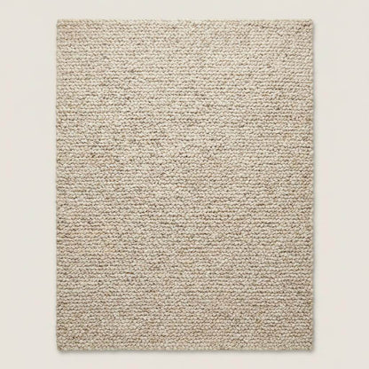 Handmade chunky wool rug with thick texture in neutral tones for cozy minimalist living room decor