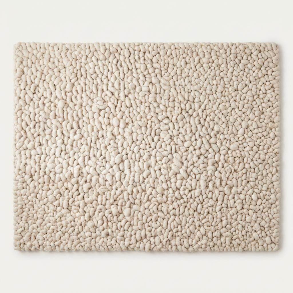 Handmade chunky wool rug with thick texture and neutral color for cozy minimalist home decor