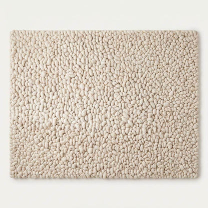 Handmade chunky wool rug with thick texture and neutral color for cozy minimalist home decor