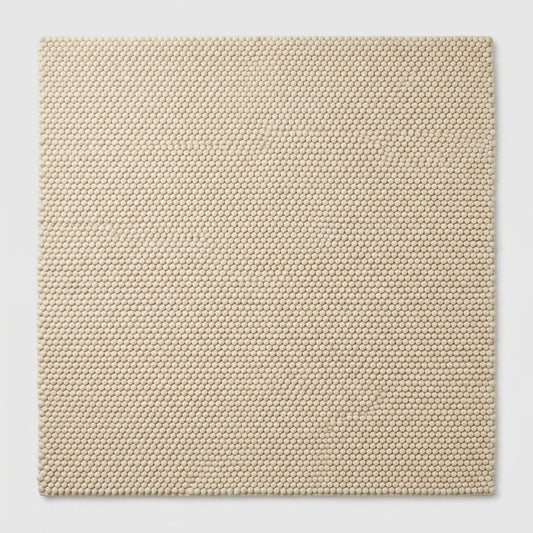 Chunky Wool Rug in natural sand beige, with a dense, raised loop-woven texture and clean rectangular shape.