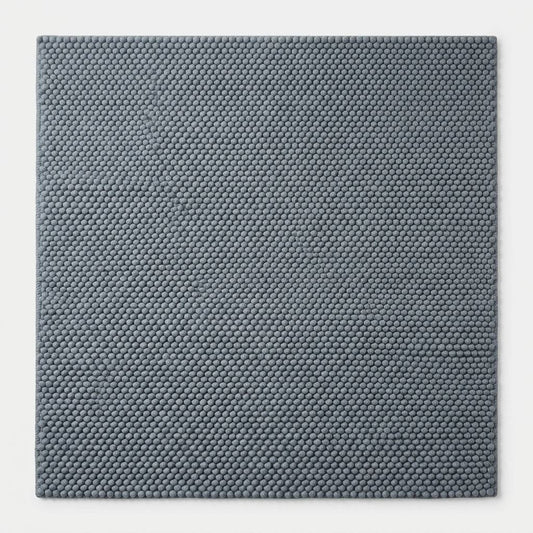 Chunky Wool Rug in slate blue-gray, with a dense handwoven pebble texture and thick, rounded pile.