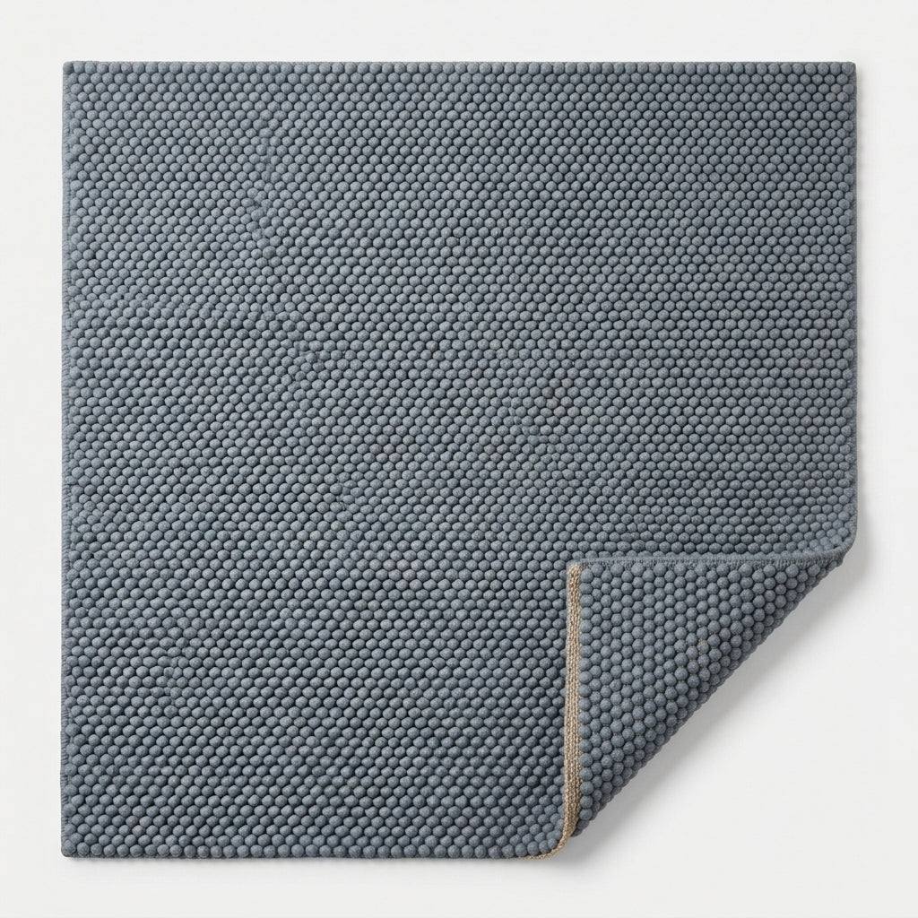 Chunky Wool Rug in slate blue-gray, with a dense handwoven pebble texture and thick rounded pile
