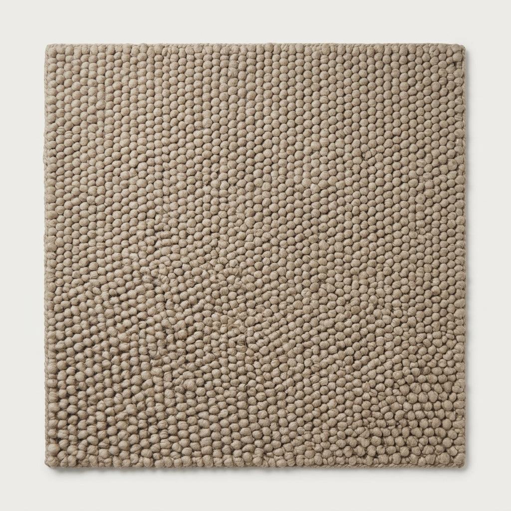 Chunky Wool Rug in taupe greige, with a thick handwoven surface of tightly packed rounded pebble knots and finished edges.