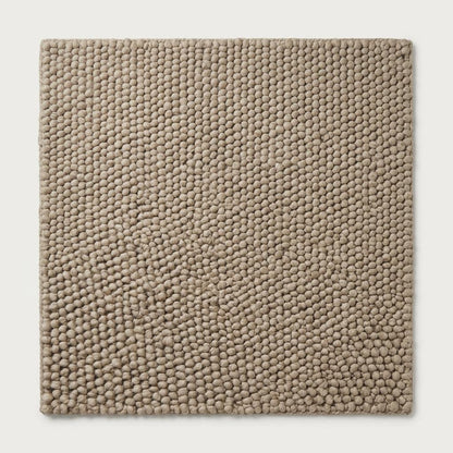 Chunky Wool Rug in taupe greige, with a thick handwoven surface of tightly packed rounded pebble knots and finished edges.