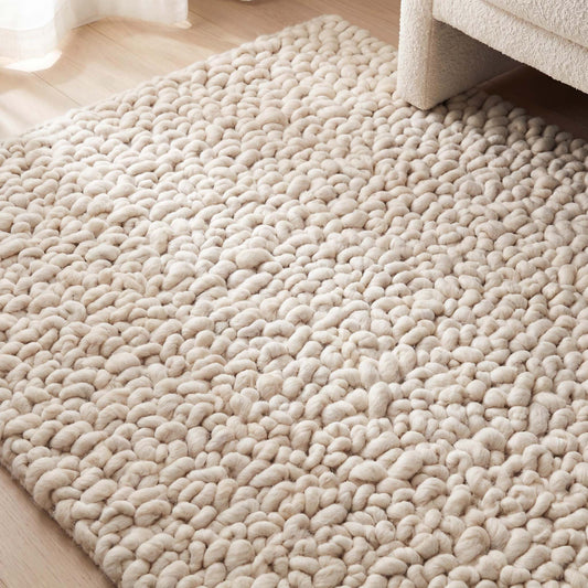 Handmade chunky wool rug with thick, textured loops in a neutral color for cozy, minimalist home decor