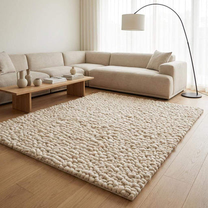 Handmade chunky wool rug with thick textured loops in neutral tone for cozy minimalist home decor