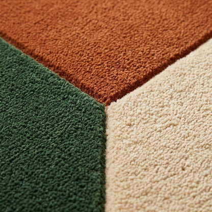 Color Block Rug in textured wool, showing forest green, burnt orange and cream geometric sections meeting in a crisp point