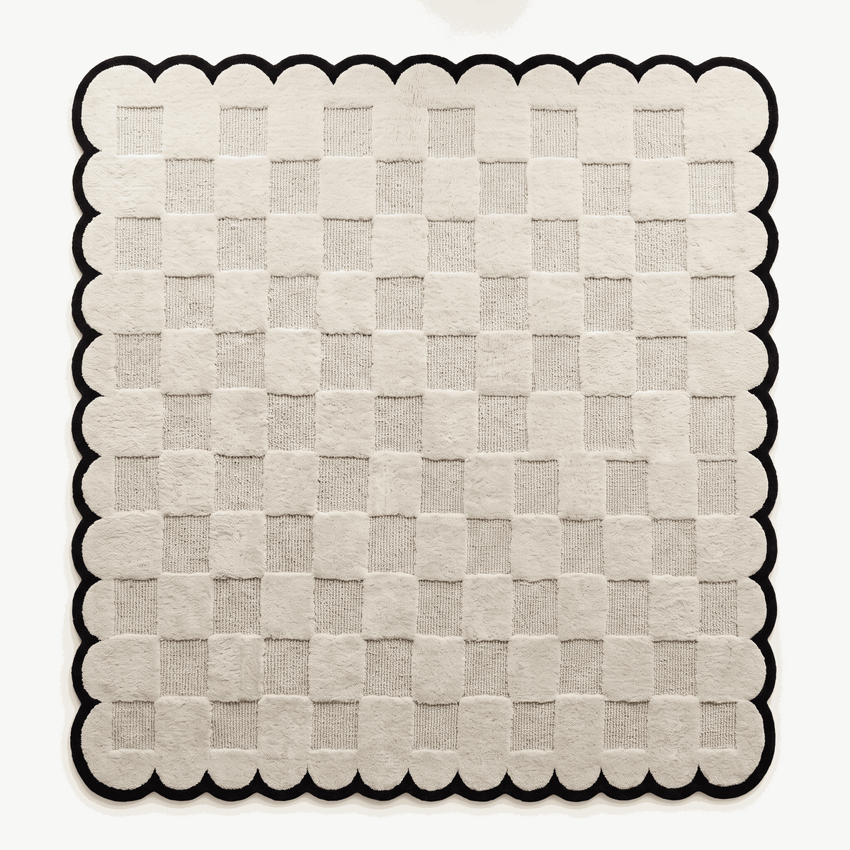 Cream & Black Checkered hand-tufted wool rug with a raised cream checkerboard and bold black scalloped border