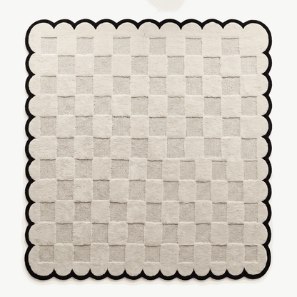 Cream & Black Checkered hand-tufted wool rug with a raised cream checkerboard and bold black scalloped border