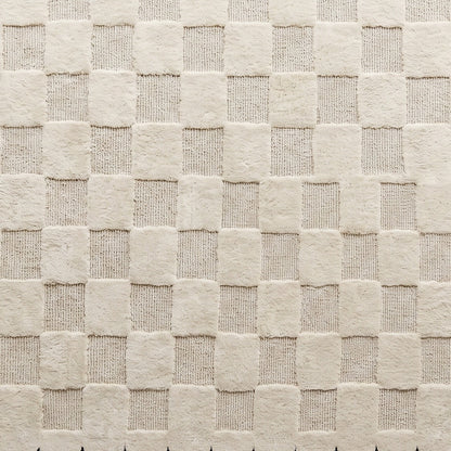 Cream & Black Checkered hand-tufted wool rug with a raised ivory checkerboard and alternating plush and looped textures