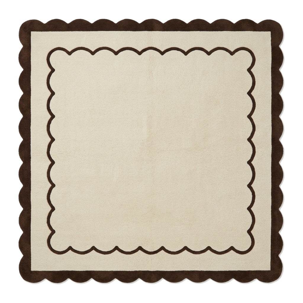 Cream and brown wool rug with a plush surface, featuring the Cream & Chocolate Scalloped Border and wavy edges.