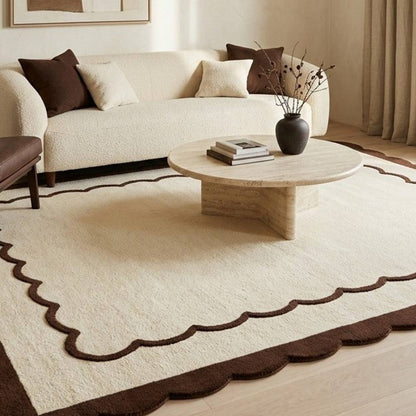 Scalloped wool rug, cream with a chocolate brown wavy border and fine inner line; Cream & Chocolate Scalloped Border style.