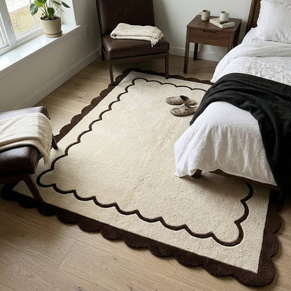 Hand-tufted wool rug, Cream & Chocolate Scalloped Border, with a plush ivory field and wavy brown edges.