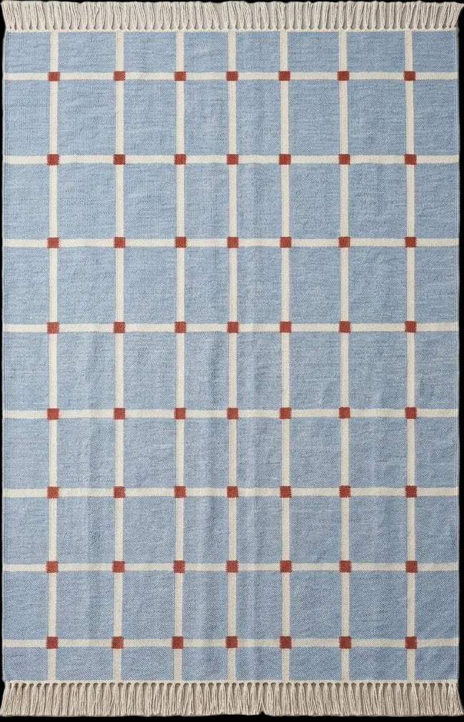 Handwoven flatweave blue grid rug with terracotta accents for modern farmhouse living room