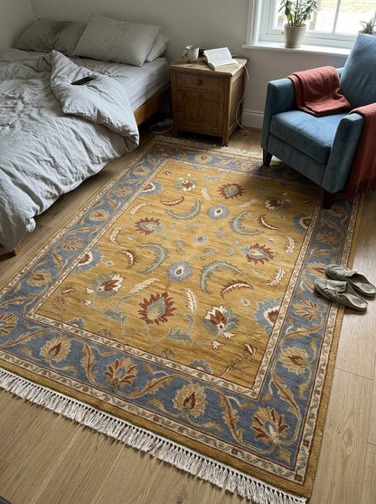 Gold Oushak Rug with a mustard wool field, blue floral border, multicoloured palmettes and cream fringe