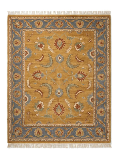 Gold Oushak Rug in mustard wool with rust, blue, sage and ivory floral motifs, slate blue border and fringe