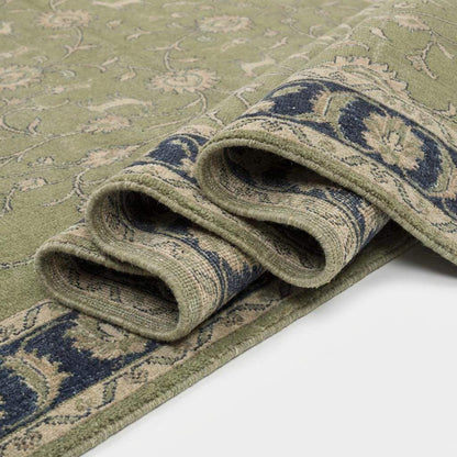 Green Oushak floral animal pattern hand-knotted wool area rug with sage green field and navy border