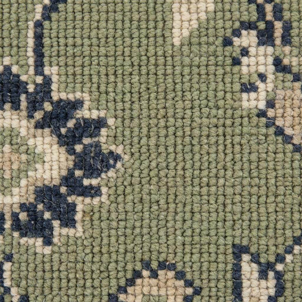 Green Oushak floral animal pattern hand-knotted wool area rug with sage field and navy border
