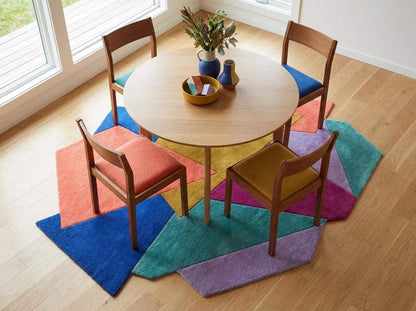 Hand tufted abstract geometric rug with modern color block design and plush texture in contemporary interior setting