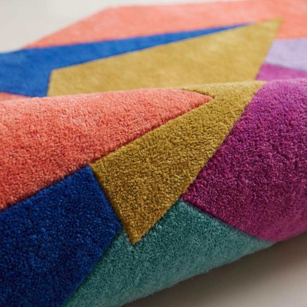 Modern hand tufted abstract geometric rug with vibrant color blocks and plush wool pile