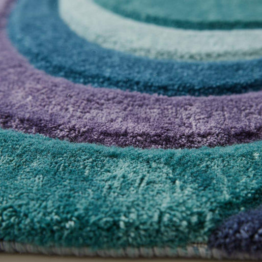 Close-up of hand tufted high pile rug showing thick plush fibers, soft texture, and dense craftsmanship with blended teal and purple yarns. __etsy:7591915041