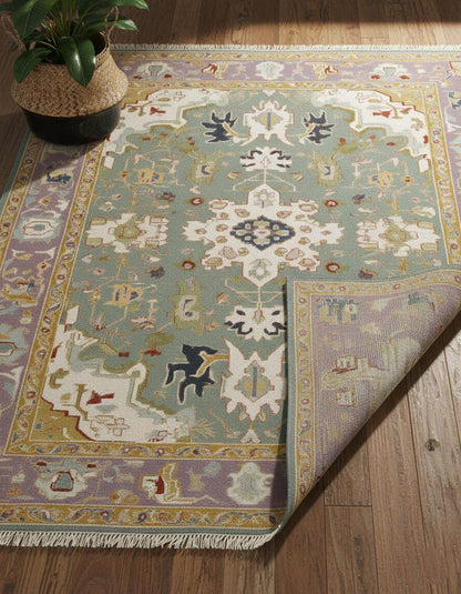 Hand-tufted wool area rug with vintage pastel medallion and boho Persian design