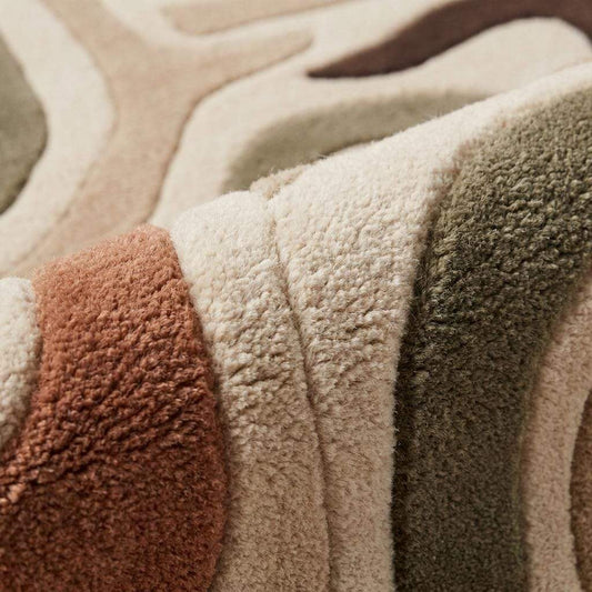Hand tufted wool rug with abstract retro wavy pattern in neutral earthy tones for mid century modern decor