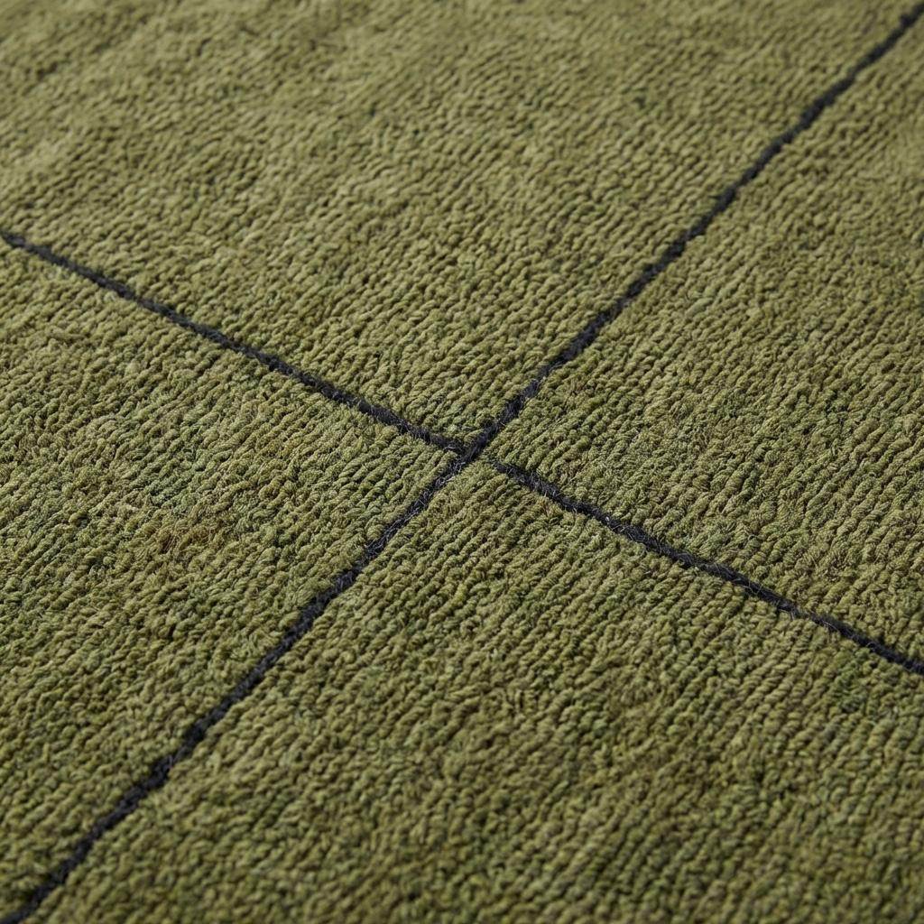 Close-up of hand tufted wool rug texture showing dense olive green pile with carved charcoal grid lines and soft loop surface detail __etsy:7728060922