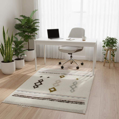 Hand-woven wool rug with pastel Moroccan diamond pattern in blush pink and powder blue on cream background