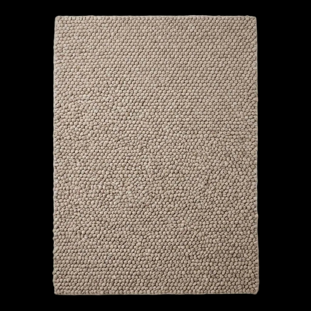 Handmade chunky wool rug with neutral pebble weave in Scandinavian minimalist Japandi living room setting