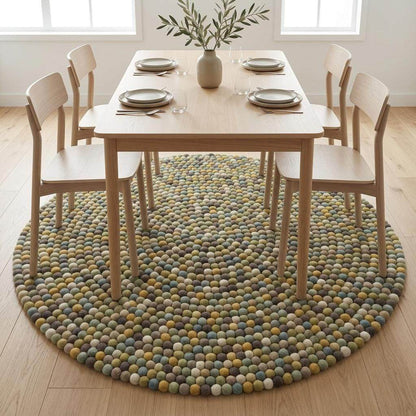 Handmade wool felt ball rug in sage green with earthy tones for nursery and boho playroom décor