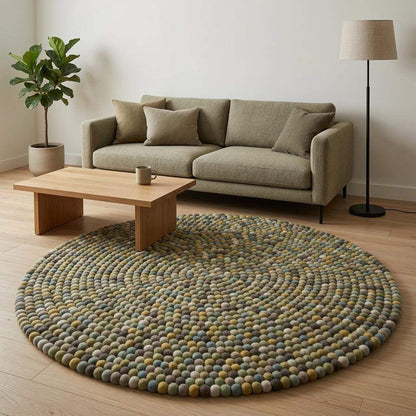 Handmade wool felt ball rug in sage green and earthy tones, round nursery carpet with boho playroom decor