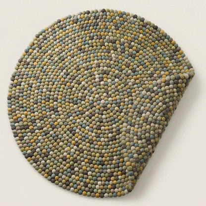 Handmade wool felt ball rug in sage green with multicolor earthy tones, round boho nursery carpet
