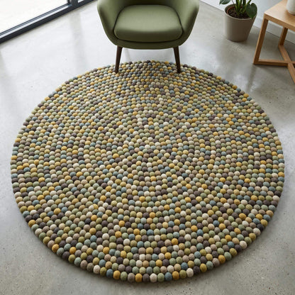Handmade wool felt ball rug in sage green and earthy tones, round nursery carpet with boho playroom decor