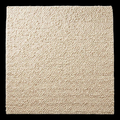 Handwoven chunky wool pebble rug in natural ivory with thick texture for modern minimalist interiors