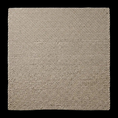Handwoven chunky wool pebble rug in neutral beige with thick texture for Scandinavian modern decor