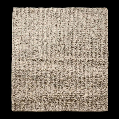 Handwoven chunky wool rug with natural beige pebble texture in Scandinavian living room setting