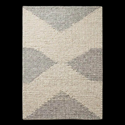 Handwoven chunky wool rug in neutral cream, beige, and gray tones with chunky weave and subtle geometric pattern for Scandinavian and minimalist interiors