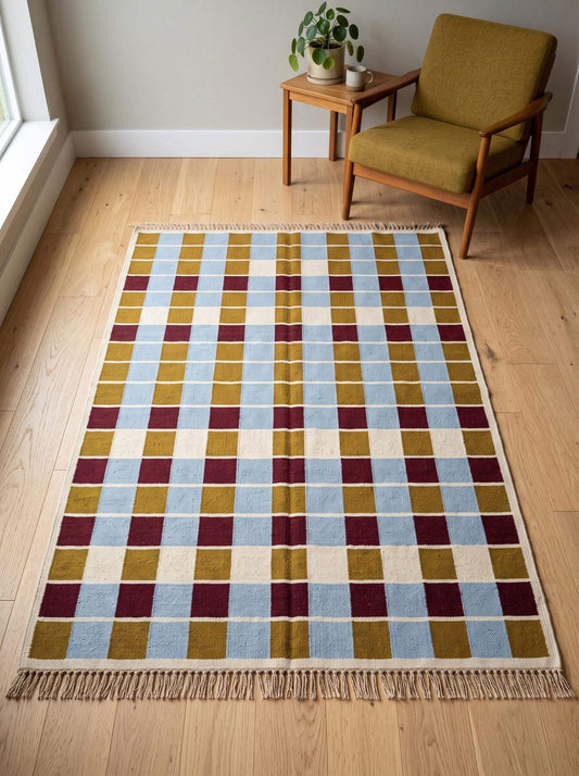 Handwoven flatweave checkered rug in mustard, dusty blue, burgundy, and ivory geometric grid pattern
