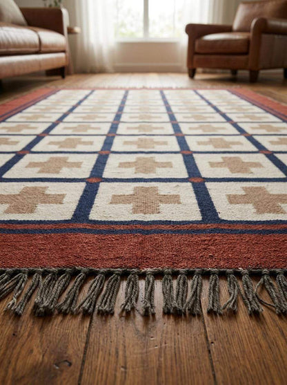 Handwoven flatweave wool rug with southwestern rust and navy geometric cross design