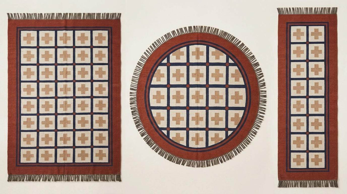 Handwoven flatweave wool rug with Southwestern rust and navy geometric cross pattern for living room